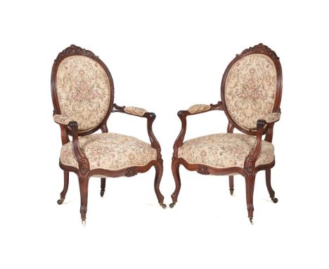 A pair of Louis XV/XVI style fauteuilsRosewoodFloral tapestry upholstered backs and seatsFrance, 19th century102x57x62 cm