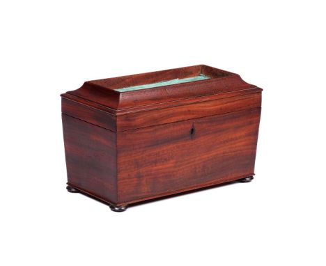 A Regency tea caddyMahogany and other timbersInner compartmentsResting on four bun feetEngland, 19th century(restoration and 