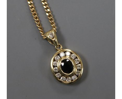 An oval yellow metal, sapphire and diamond pendant on 9ct gold fine chain, pendant 11mm.