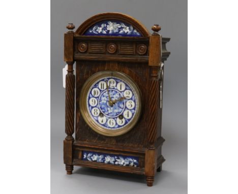 A Victorian oak mantel clock inset blue and white panels height 33c,