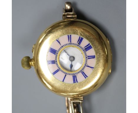 An 18ct gold and enamel half hunter manual wind wrist watch by Smith &amp; Son, London, on a 9ct gold bracelet.