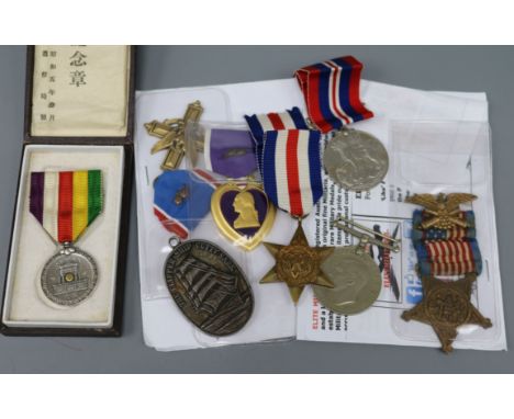 A group of medals comprising a U.S Distinguished Service Cross a Grand Army of the Republic Veterans Badge, a Purple Heart, 3