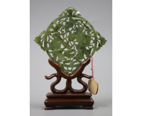 A 19th century Chinese spinach green jade plaque, wood stand H.12cm