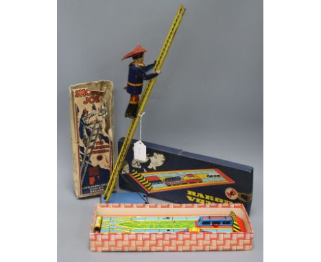 A Marx Smokey Joe climbing fireman tin plate toy and a Rakoda Vonat tin plate toy