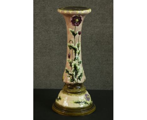 An early 20th century relief poppy design ceramic planter stand on cream ground and green detailing. H.60 Dia.26cm. 