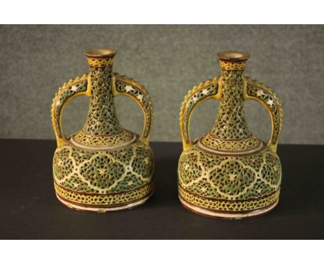A pair of 19th century Zsolnay vases with double walls and reticulated mallet form. Decorated predominantly in green and ochr