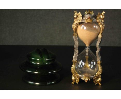 A gilt metal egg timer and a ceramic electricity conductor. H.28 Dia.12cm. 