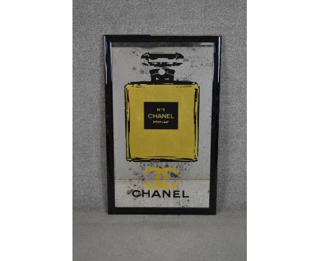 A black framed vintage style mirror with a Chanel style perfume bottle motif and lettering. H.99 W.60cm 