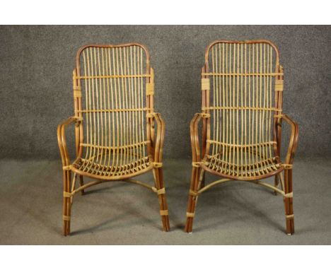 A pair of vintage bamboo and wicker conservatory armchairs. 