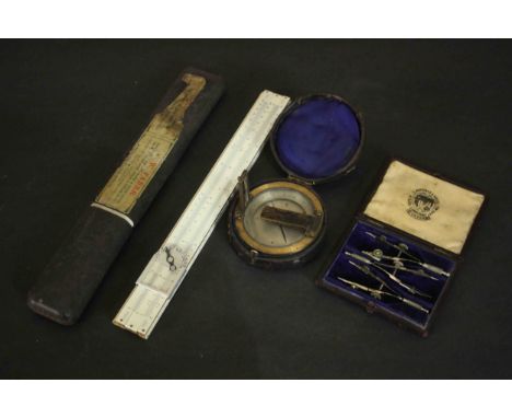 A leather cased 19th century compass along with a boxed slide rule and leather cased set of measuring instruments. L.30 W.36c