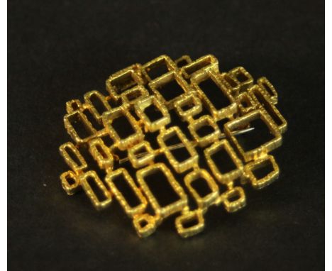 An 18 carat yellow gold mid-century brutalist design openwork brooch. Stamped 750 with S with a line through mark. L.4 W.4cm.