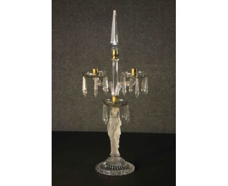 A vintage cut glass twin branch table candelabra the sconces hung with lustre drops supported by robed classical female to th