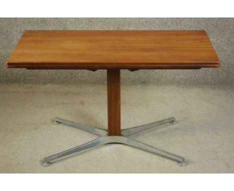 A vintage teak fold over console table converting to dining table with height adjustable mechanism raised on teak and metal b