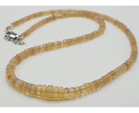 A fire opal gemstone single row necklace. Length 21cm, weight 9.16g. 