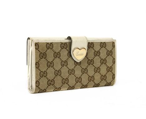 A Gucci beige monogrammed canvas and cream leather heart bi-fold wallet, gold-tone hardware, front heart press stud closure, 