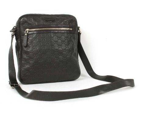 A Gucci black leather crossbody messenger bag, gold-tone hardware, single flat leather strap, zip front pocket, zip-top closu