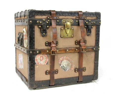 A Louis Vuitton cabin trunk, early 20th century, stamped to the lock and studs, the hinged lid enclosing a canvas-lined inter