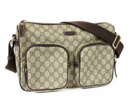 A Gucci beige coated canvas shoulder bag, dual front pockets with zip closure, gold-tone hardware, brown canvas flat shoulder