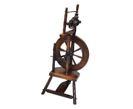  Oak pedal-operated spinning wheel with turned frame, spoke wheel and splayed tripod supports, 88cm high.
