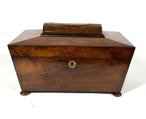 A Victorian mahogany sarcophagus tea caddy, 19th century, of typical form, with hinged lid and opening to two tea canisters a