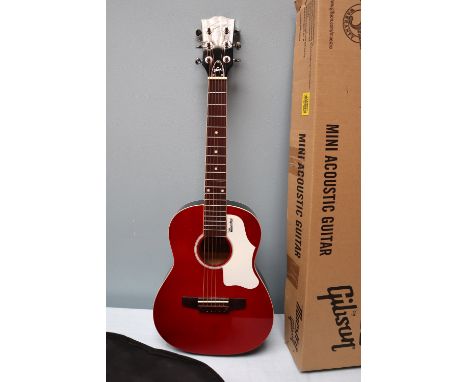 A Gibson Maestro Mini Acoustic Guitar, a small sized steel string guitar in red with a white scratchplate, with a soft case a