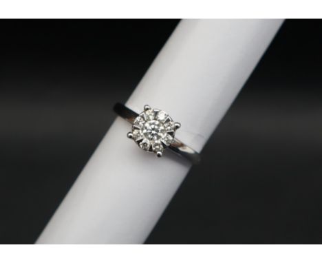 A diamond cluster ring set with a central old round cut diamond surrounded by eight round cut diamonds to an 18ct white gold 
