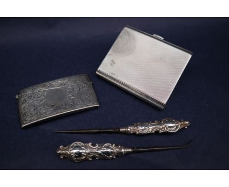 A late Victorian silver card carrying case, of bowed rectangular form decorated with scrolling leaves, Chester, 1899, William