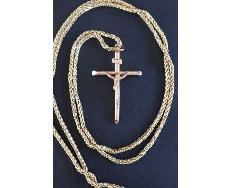 A 9ct gold crucifix on a 9ct gold long chain, 93.5cm long, approximately 12 grams