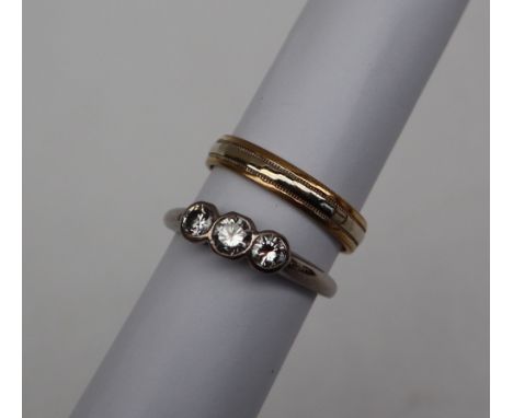 A three stone diamond ring set with graduating round brilliant cut diamonds to an 18ct white gold setting and shank, size Q t