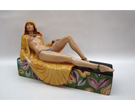 A ceramic sculpture by Peggy Davis, "Temptress", the figurine in an Art Deco style, depicting a nude lady reclining, wearing 