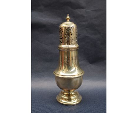 A George V silver sugar caster of baluster form with a turned finial and pierced domed top on a spreading foot, 20.5cm high, 