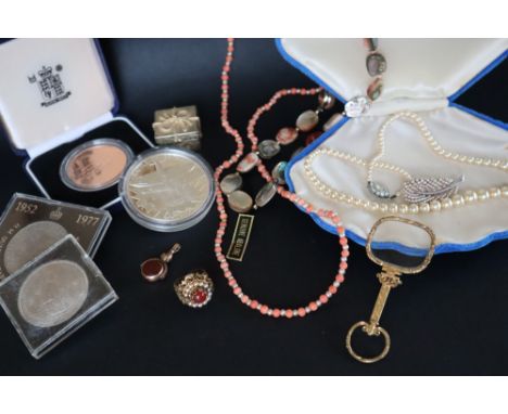 A coral and seed pearl necklace together with a faux pearl necklace, another necklace, ring magnifying glass, a revolving fob