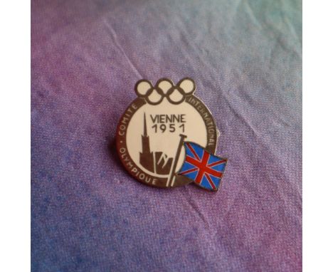 A white metal and cream enameled badge from the 45th International Olympic Committee session held in Vienna Austria, in 1951,