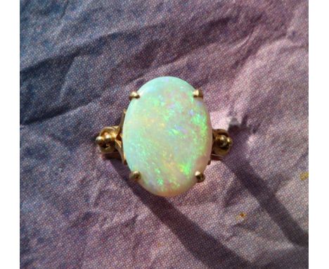 A 14ct gold opal ring, the oval opal approximately 16mm x 12mm, to a 14ct yellow gold claw setting and shank, size N, approxi