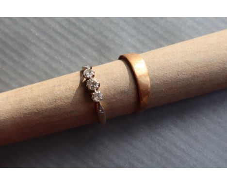 A three stone diamond ring set with old round cut diamonds to a platinum setting and 18ct yellow gold shank, size M together 