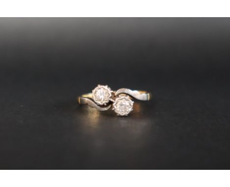 A two stone diamond ring set with round old cut diamonds each approximately 0.10cts to a platinum setting and 18ct yellow gol