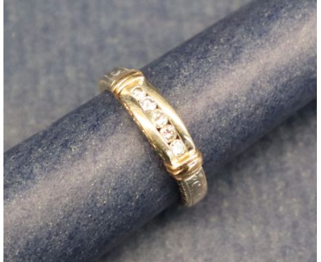 A five stone diamond ring, set with channel set round brilliant cut diamonds to a two tone 18ct gold setting and shank, size 