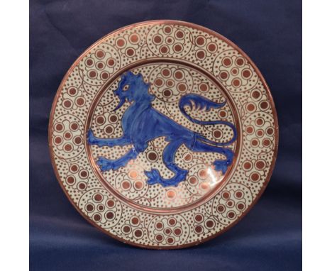 An Hispano Moresque type lustre charger with a central blue dragon, scrolls and stylised flowerheads, 35.5cm diameter CONDITI