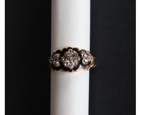 A late 18th / early 19th century diamond and black enamel mourning ring set with fifteen rose cut diamonds to a yellow metal 
