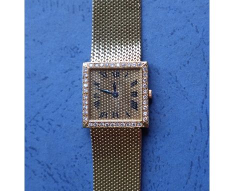 An 18ct yellow gold lady's Piaget wristwatch, the square dial with diamond set bezel and Roman numerals on an 18ct yellow gol