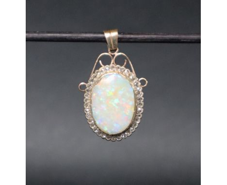 An opal and diamond pendant, the oval opal surrounded by rose cut diamonds to a yellow metal mount, 32mm high including suspe