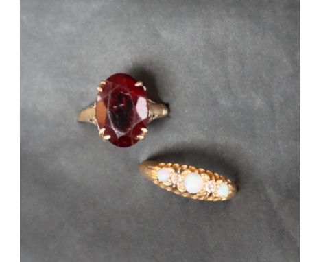 An 18ct yellow gold opal and diamond ring set with three cabochon opals and two old round cut diamonds, size N 1/2, approxima