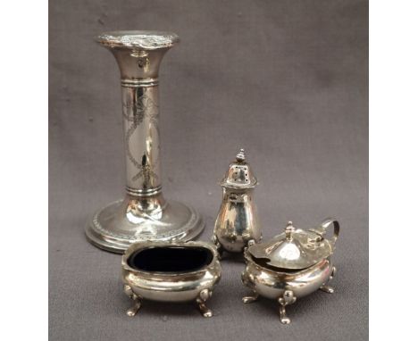 A George V silver desk candlestick with a cylindrical column with swags on a circular base, Birmingham, 1910 together with a 