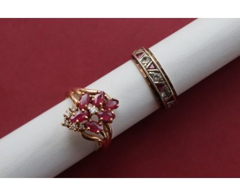 A ruby and diamond cluster ring set with six marquise cut rubies and six round brilliant cut diamonds to a 14ct gold setting 
