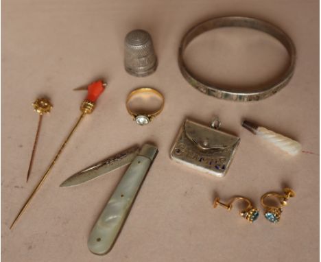 A 22ct gold paste set ring, overall approximately 1.8 grams together with a coral stick pin in the form of a fist holding a d