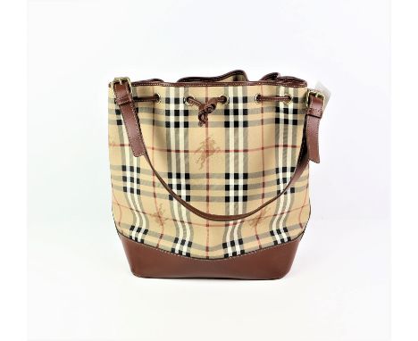 BURBERRY beige and brown leather trimmed coated canvas Haymarket Check large bucket bag with brass hardware and top handle. (