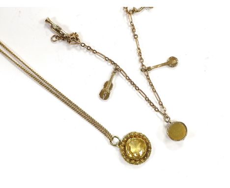A small 9ct gold charm bracelet, hung with three assorted charms, gross weight 3 grams and a yellow metal and citrine set pen