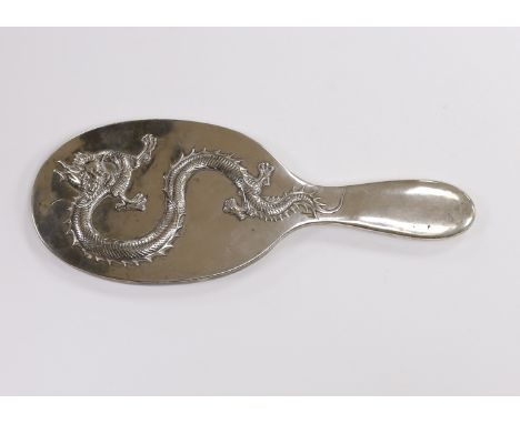 A Chinese Export white metal mounted oval hand mirror, decorated with a dragon, 25.2cm.