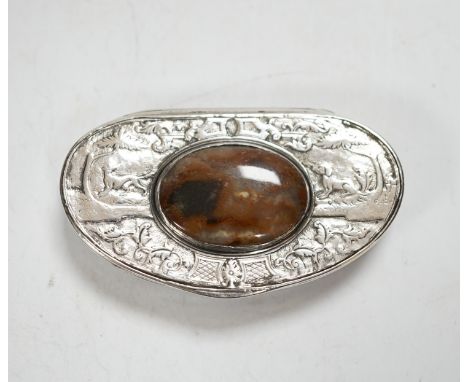 An early 19th century Scottish? white metal oval snuff box, with banded agate base and inset agate lid, decorated with dogs a
