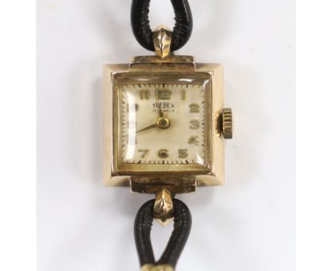 A lady's 9ct gold Trebex manual wind wrist watch, on a twin fabric strap.